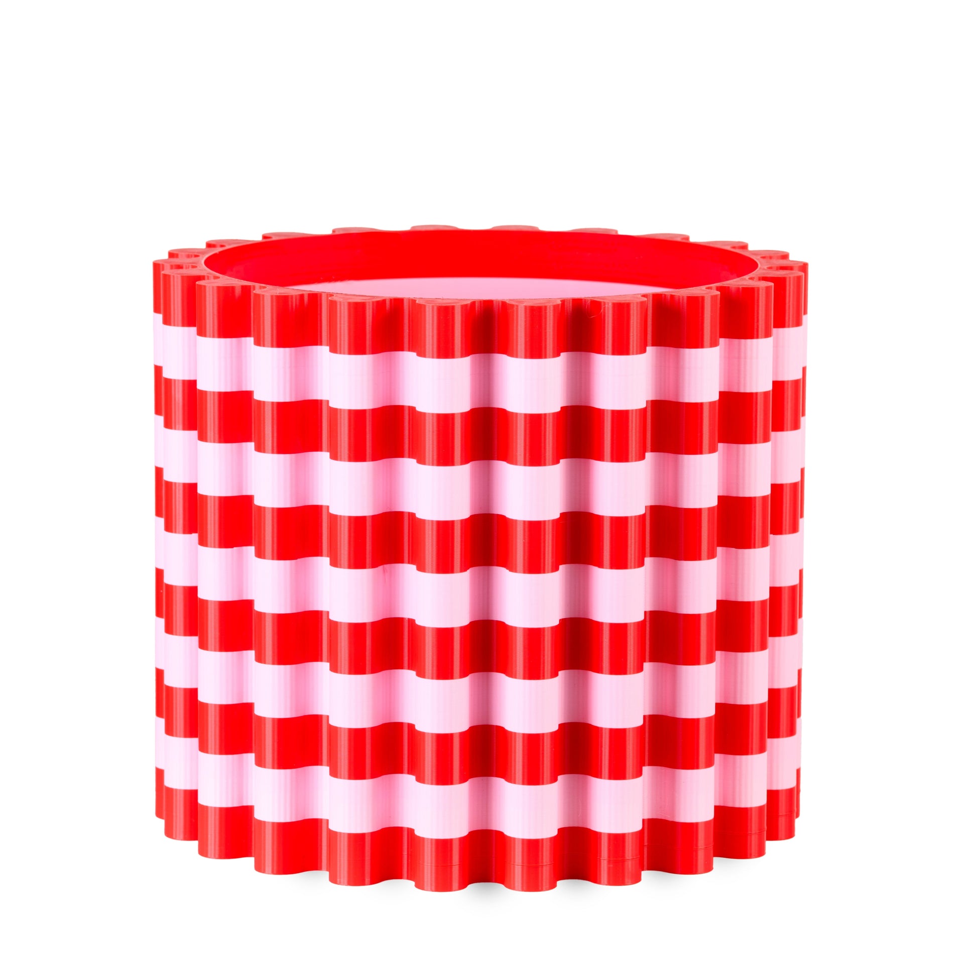 Red and white striped cylindrical flowerpoton a white background