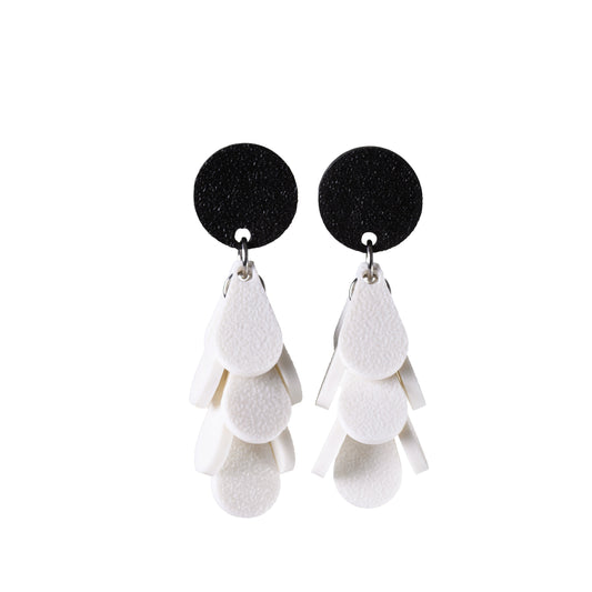 Black and white dangle earrings on a white background
